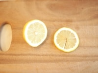 レモンを半分にカットして、一枚分薄くスライスしておきます。<br />
<br />
半分にカットした実の部分は、絞ってレモン汁にします。<br />
スライスにしたものは、中央から一カ所切り込みを入れておきます。