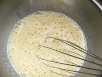 ボウルに卵を割り入れてほぐす。小鍋に豆乳と砂糖を入れて人肌に温めて砂糖を溶かし、卵のボウルに流し入れて混ぜ、バニラエッセンスを加えて混ぜる。こしザルを通す。<br />