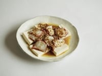 豆腐を皿に並べた上に、タコを乗せ、和風ソースをかけます。手でちぎった焼き海苔、貝割れ大根をかけたら、できあがり。