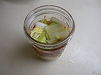 1の水気を絞った白菜とヤンニョムを、瓶に交互に詰めていきます。