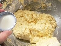ゴムベラに持ちかえて、【1】の粉を3回に分けて加え、そのつど切るようにさっくりと混ぜる。ボテッと重い生地に牛乳を混ぜて、生地を少し柔らかくする。 