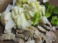 フライパンに油と赤唐辛子の輪切りを加え火にかけ豚肉を炒め、色が変わったら野菜を加えて炒める