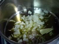 厚底鍋に、オリーブオイル、みじん切りにしたエシャロットとタマネギを入れ火にかける。<br />