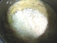 途中、ブイヨンが足りなくなったら、随時加える。米が鍋底に張り付かないように気をつけながら、リゾットを炊く。20分ほど炊いたら火を止めて、すりおろしたパルミジャーノチーズと牛乳、EXVオリーブオイル大さじ2杯（分量外）を入れて、よく混ぜて皿に盛る。<br />